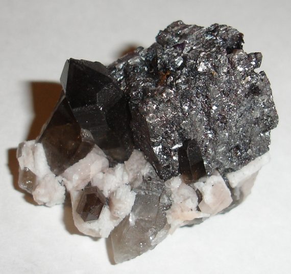Hematite (after siderite?) pseudomorph, smoky quartz, and microcline