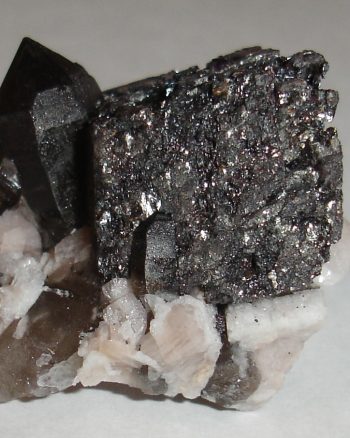 Hematite (after siderite?) pseudomorph, smoky quartz, and microcline