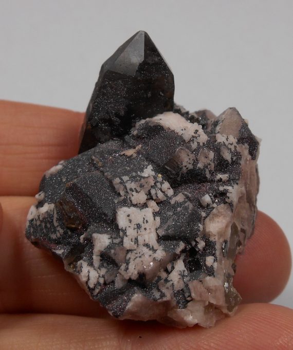 Smoky quartz, microcline, albite, and specular hematite