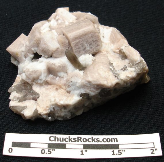 Smoky quartz, microcline (one crystal exhibits a Manebach twin), and albite on matrix