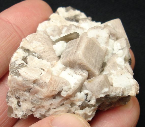 Smoky quartz, microcline (one crystal exhibits a Manebach twin), and albite on matrix