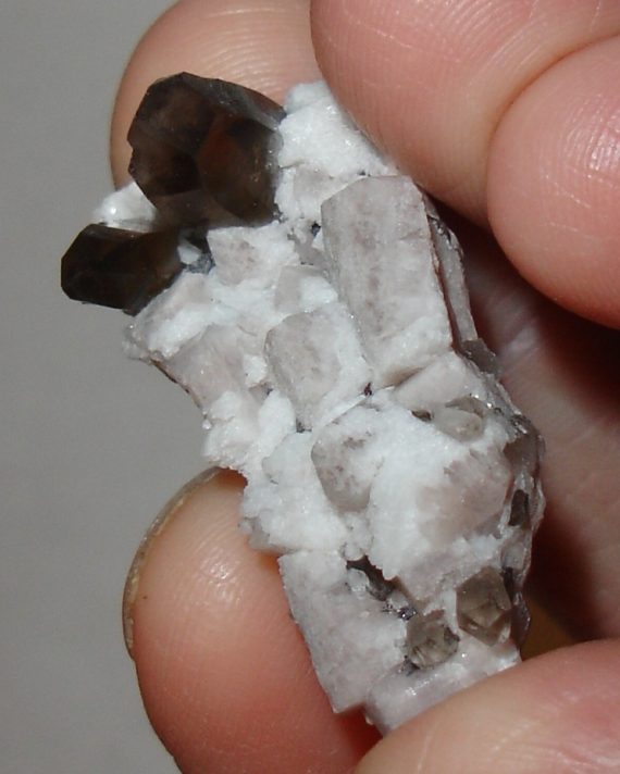 Smoky quartz, microcline, and albite on matrix