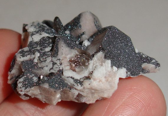Microcline, albite, smoky quartz, and specular hematite