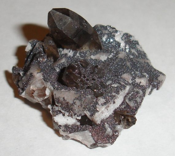 Smoky quartz, microcline, and specular hematite on matrix