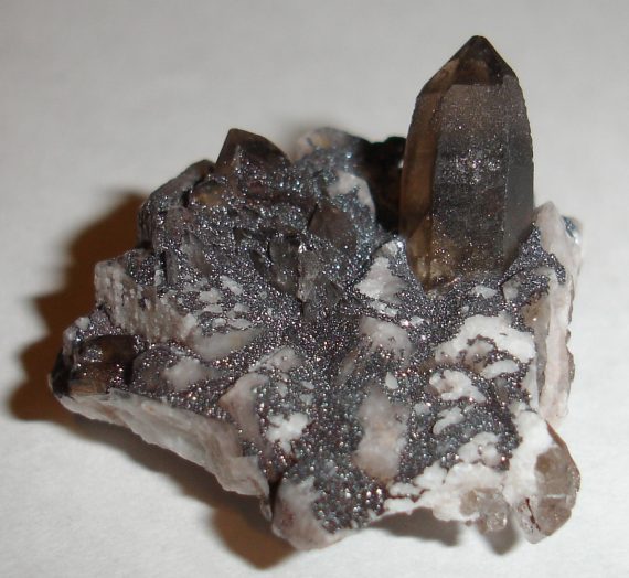 Smoky quartz, microcline, and specular hematite on matrix