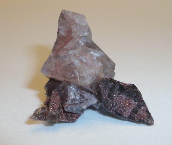 A complex specimen of smoky quartz, fluorite, and specular hematite
