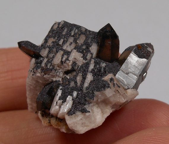 Smoky quartz, microcline, and specular hematite