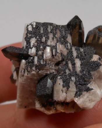 Smoky quartz, microcline, and specular hematite