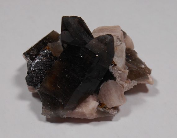 Smoky quartz, microcline, and hematite pseudomorph