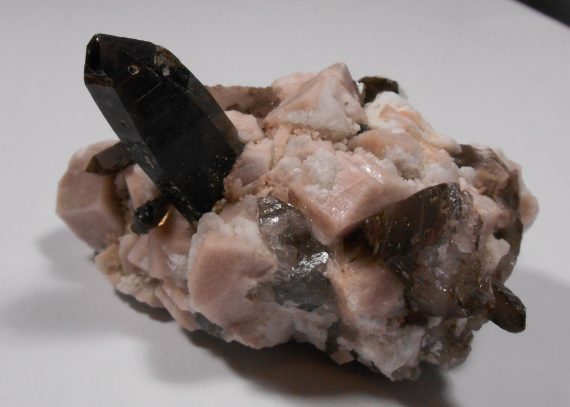 Smoky quartz, microcline, and albite on matrix