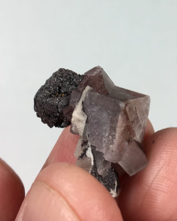 Fluorite, hematite after siderite pseudomorph, and microcline