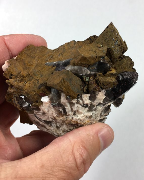 Limonite pseudomorph (after siderite?), smoky quartz, and fluorite
