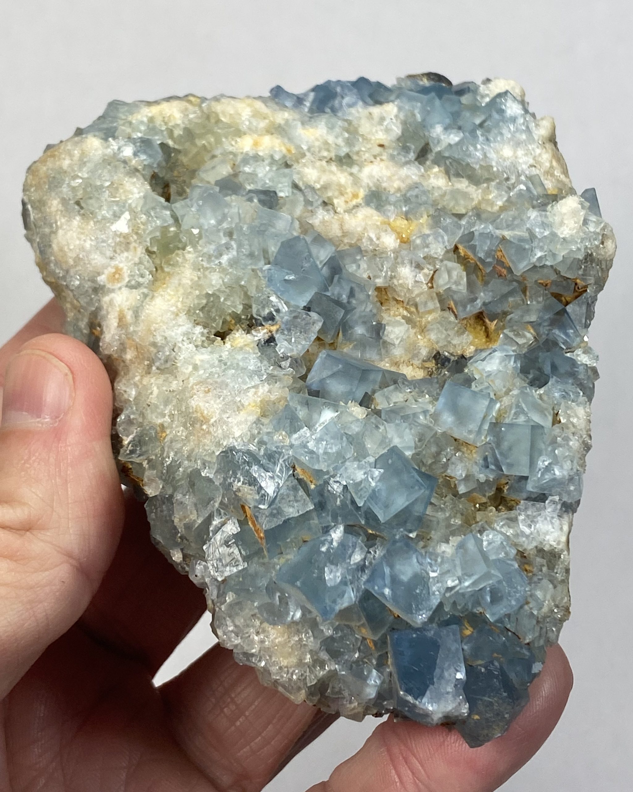 Delicate blue fluorite crystals on matrix
