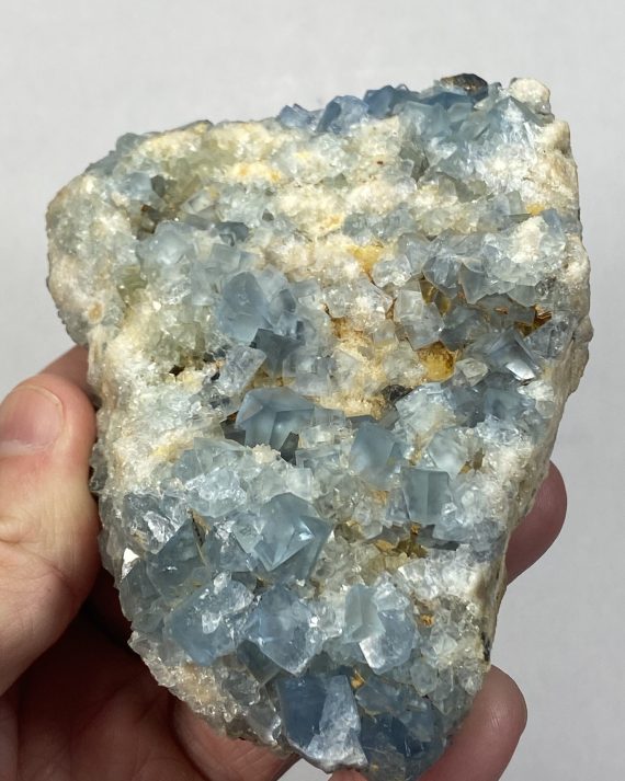 Delicate blue fluorite crystals on matrix